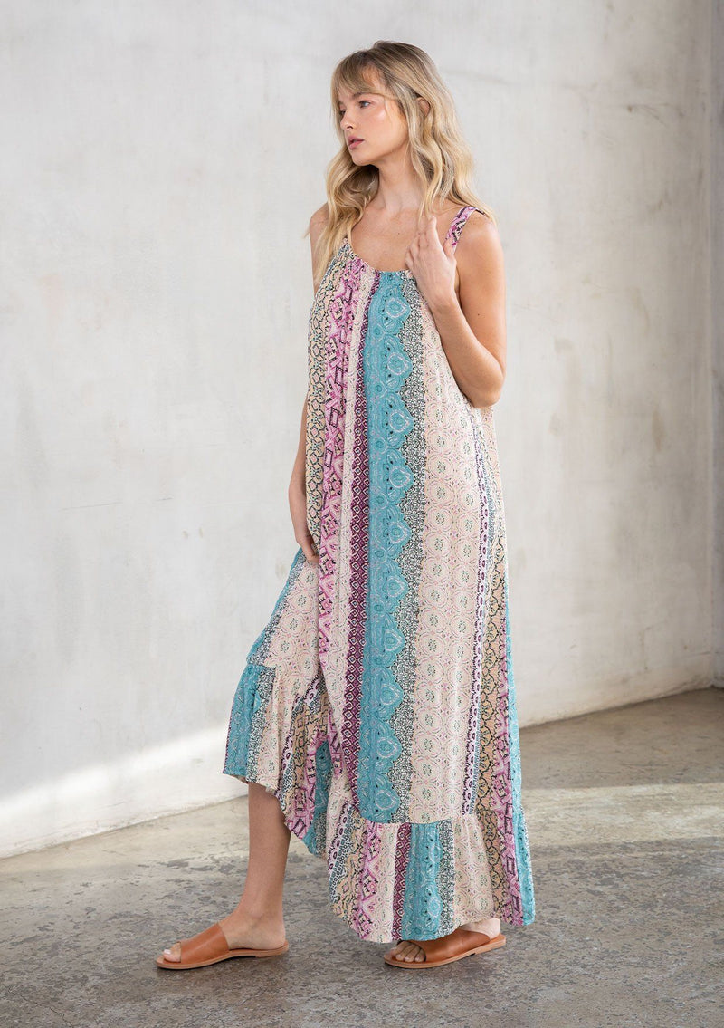 [Color: Mauve Multi] A model wearing a vacation ready sleeveless maxi dress in a multicolor mixed print. With a ruffled round neckline, a relaxed flowy fit, and metallic thread details.