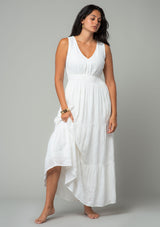 [Color: Off White] A front facing image of a brunette model wearing a sleeveless white bohemian eyelet maxi dress. With a v neckline, a long tiered skirt, and a smocked elastic waist. A classic bohemian white maxi dress for Summer. 
