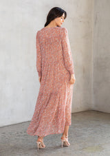 [Color: Coral/Natural] A model wearing an ethereal maxi dress in sheer chiffon, designed in a bohemian coral paisley print. With gold lurex details, long sleeves, and a button front. 