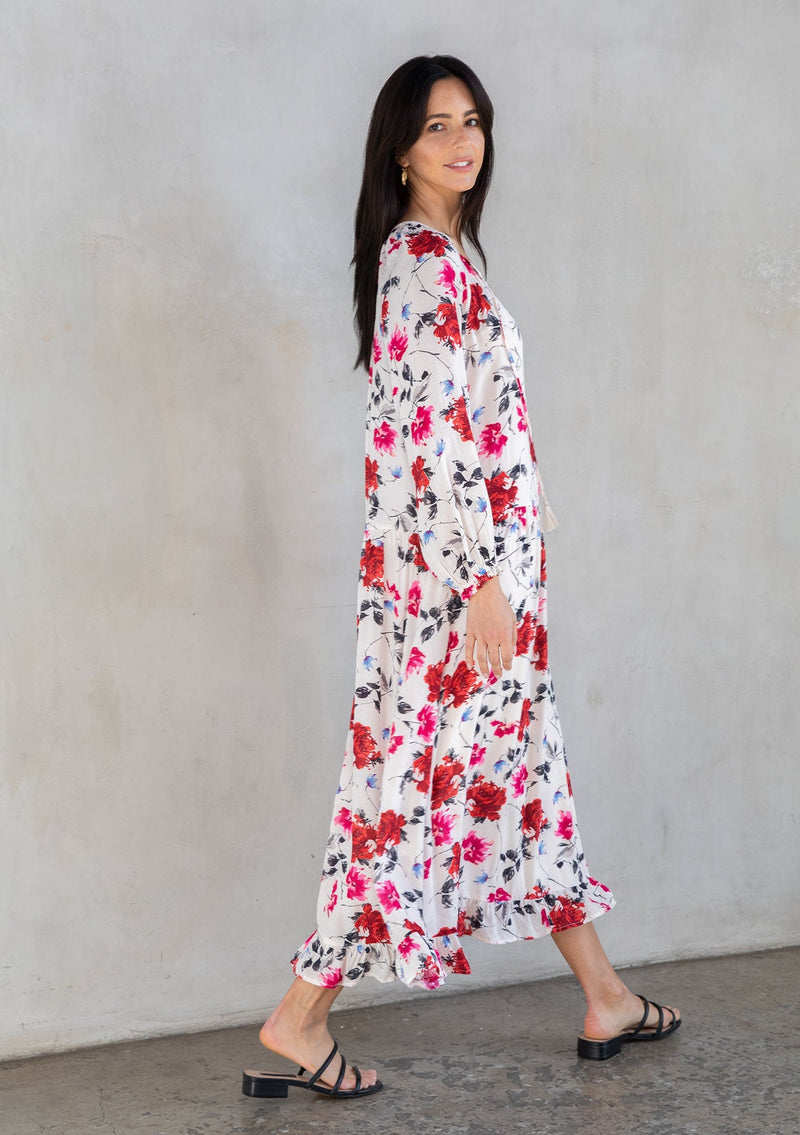 [Color: Cream/Red] A model wearing a bohemian white maxi dress in a red floral print. 