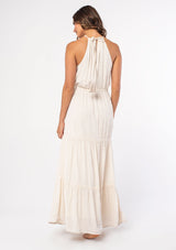 [Color: Off White/Taupe] A model wearing an off white flowy bohemian maxi dress with a halter tie neckline and embroidered front. 