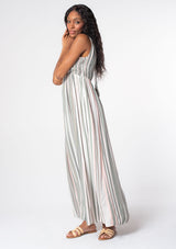 [Color: Olive/Pink] A woman wearing a bohemian sleeveless striped maxi dress in an olive green and pink stripe. With a plunging v neckline and gold metallic thread detail. 