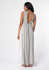 [Color: Olive/Pink] A woman wearing a bohemian sleeveless striped maxi dress in an olive green and pink stripe. With a plunging v neckline and gold metallic thread detail. 