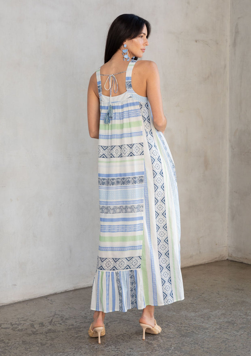 [Color: Blue/Sage] A model wearing a flowy bohemian cotton beach maxi dress in a blue and white multi striped pattern.