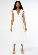 [Color: Off White] A model wearing a white mid length dress with a lace up strappy back and short flutter sleeves.