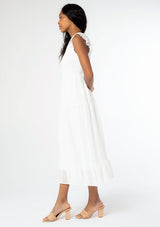 [Color: Off White] A model wearing a white mid length dress with a lace up strappy back and short flutter sleeves.