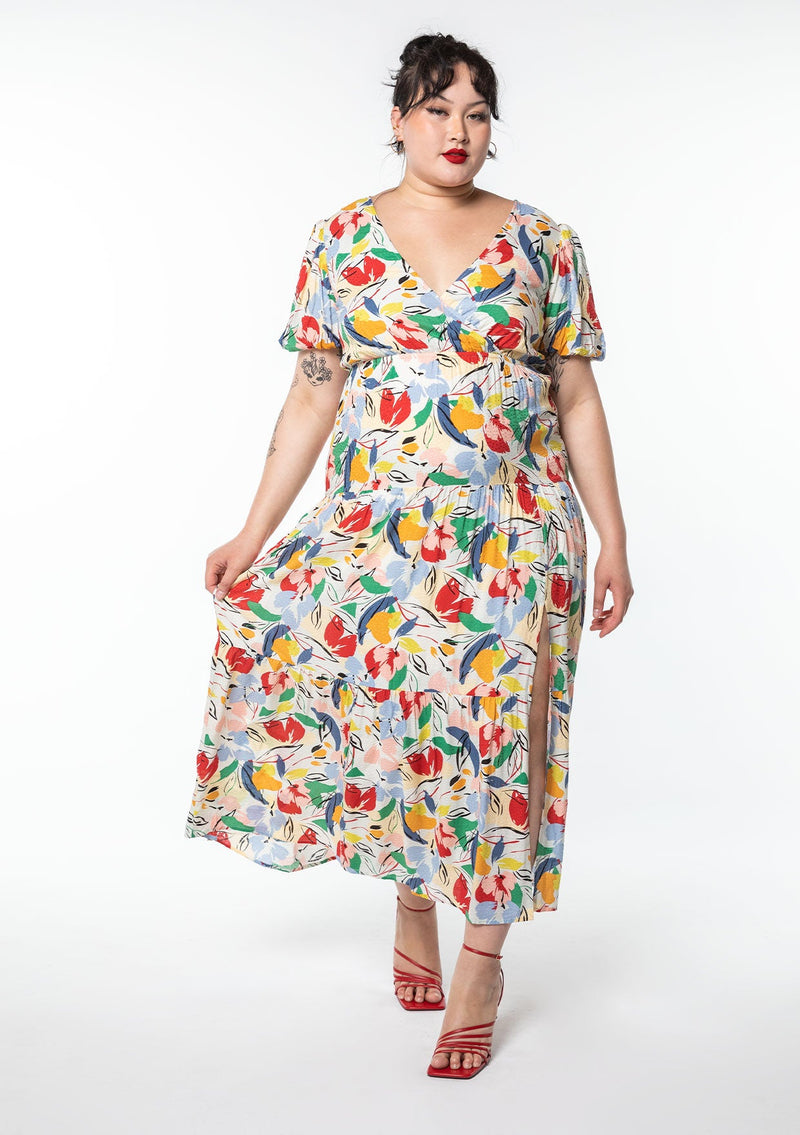 [Color: Natural/Brick Red] A model wearing a multi color watercolor floral print maxi dress with short puff sleeves.