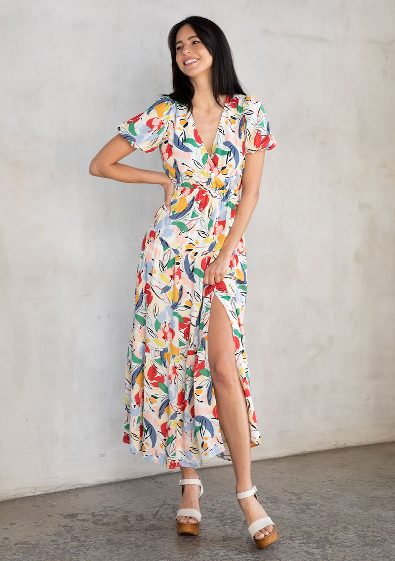 [Color: Natural/Brick Red] A model wearing a multi color watercolor floral print maxi dress with short puff sleeves. 