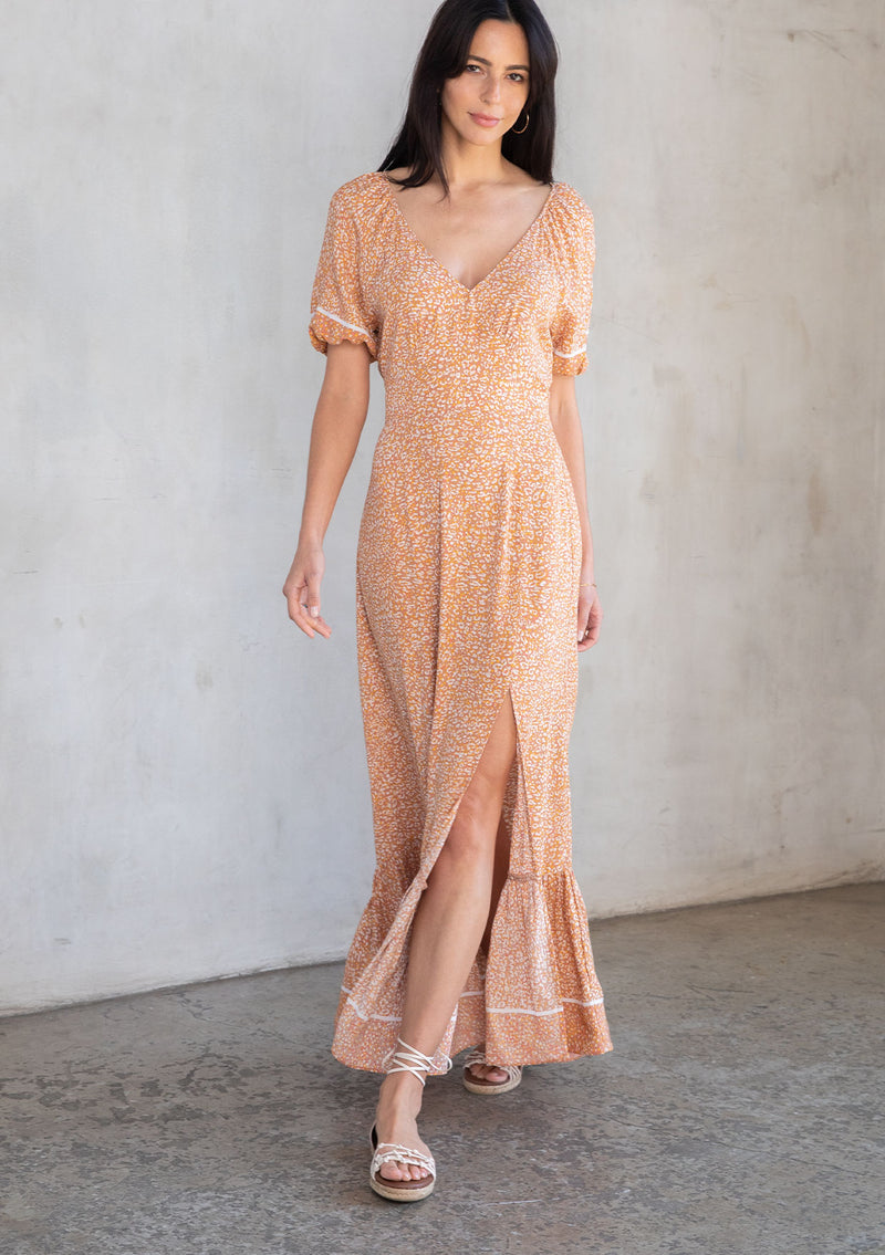 [Color: Mocha/Mustard] A model wearing a bohemian spring short puff sleeve maxi dress in a brown abstract leopard print. 