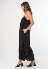 [Color: Black] An ultra flowy black bohemian sleeveless maxi dress with a strappy tie back and side pockets. 
