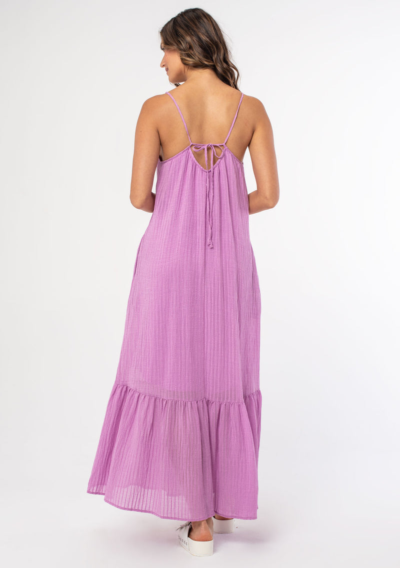 [Color: Orchid] An ultra flowy purple bohemian sleeveless maxi dress with a strappy tie back and side pockets. 