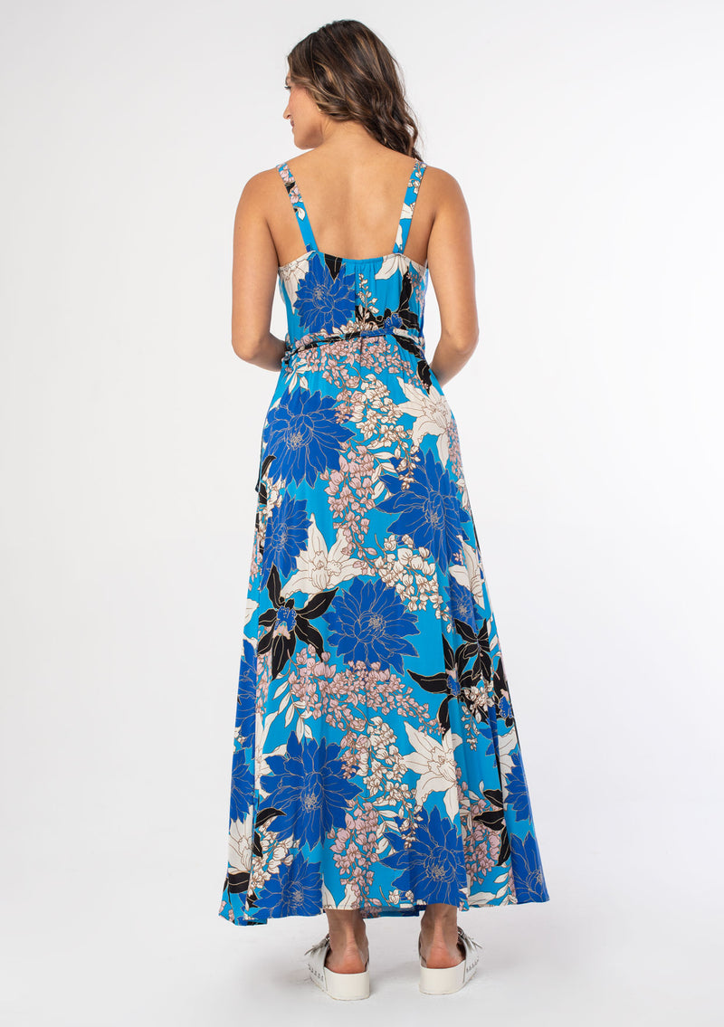 [Color: Turquoise/Black] A woman wearing a casual bohemian sleeveless maxi wrap dress in a blue floral print. 