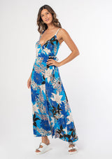 [Color: Turquoise/Black] A woman wearing a casual bohemian sleeveless maxi wrap dress in a blue floral print. 
