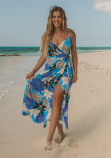 [Color: Turquoise/Black] A woman wearing a casual bohemian sleeveless maxi wrap dress in a blue floral print.
