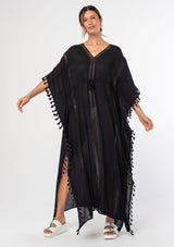 [Color: Black] A woman wearing a sheer black bohemian beach cover up maxi dress with lace and tassel trim and side slits. A kimono kaftan maxi dress perfect for vacations! 