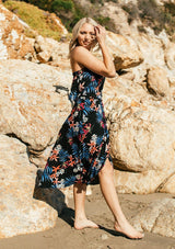 [Color: Black/Coral] A tropical floral print skirt set. With a cropped tube top and a mid length wrap skirt.