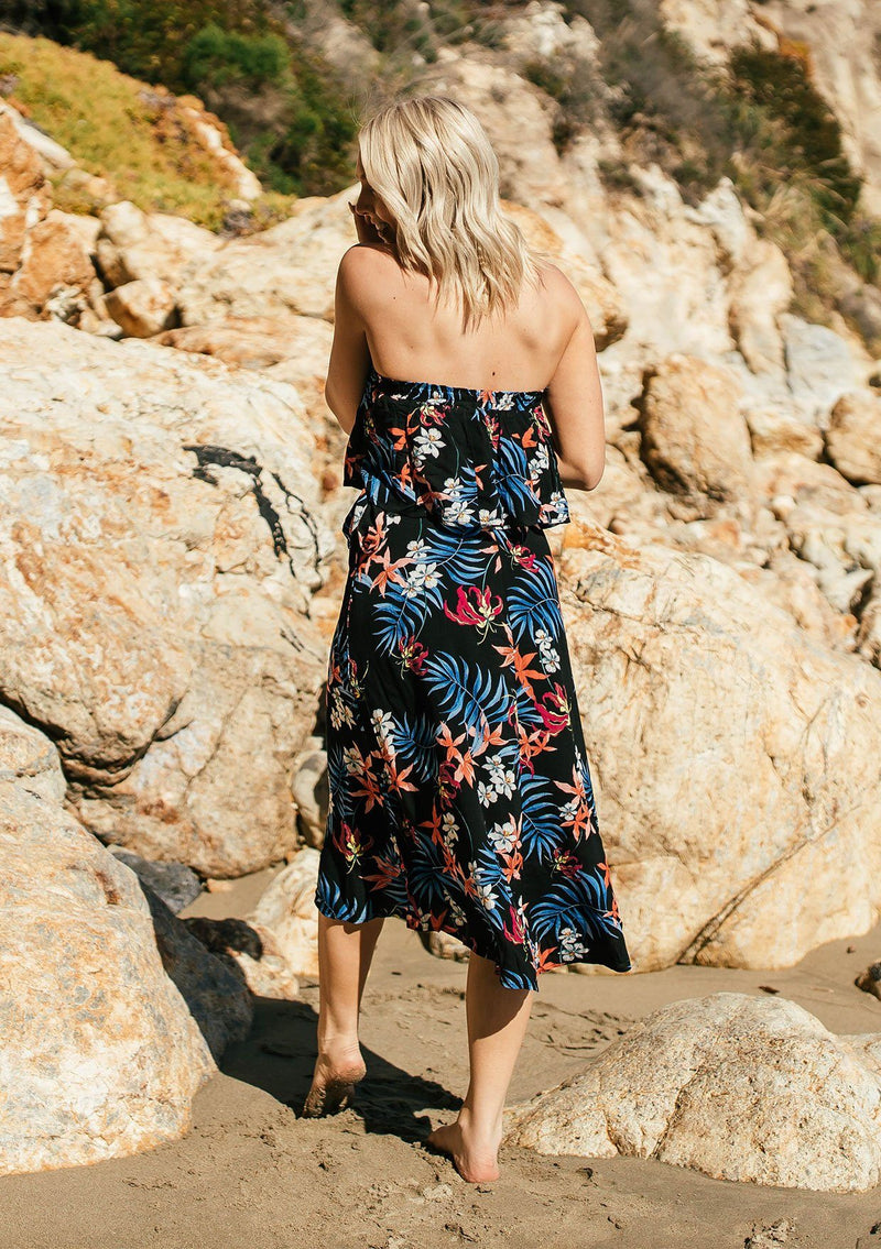 [Color: Black/Coral] A tropical floral print skirt set. With a cropped tube top and a mid length wrap skirt.