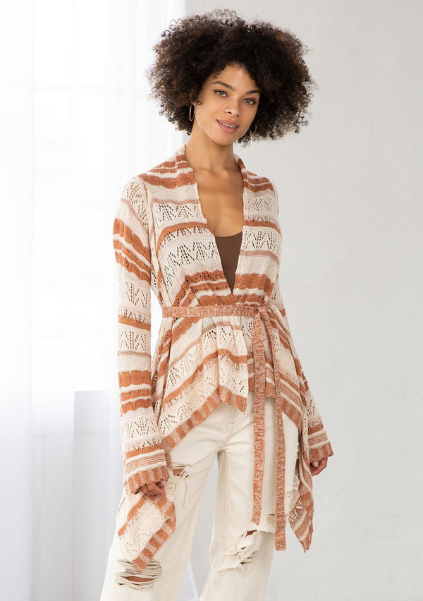 [Color: Cream/Rust] A model wearing a cream and rust striped rochet cardigan. A vintage inspired style with a waterfall hemline and a removable waist tie. 