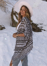 [Color: Blk/White] A bohemian cardigan with a beautiful Southwestern style pattern throughout. Featuring flattering three quarter length kimono sleeves and a fringed hemline.