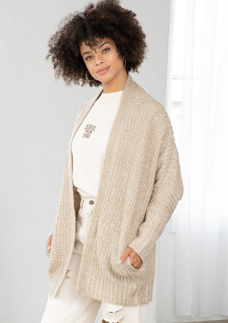 [Color: Oatmeal] An open knit marled cardigan. Featuring a flattering cocoon fit, a relaxed shawl collar, and essential side pockets.