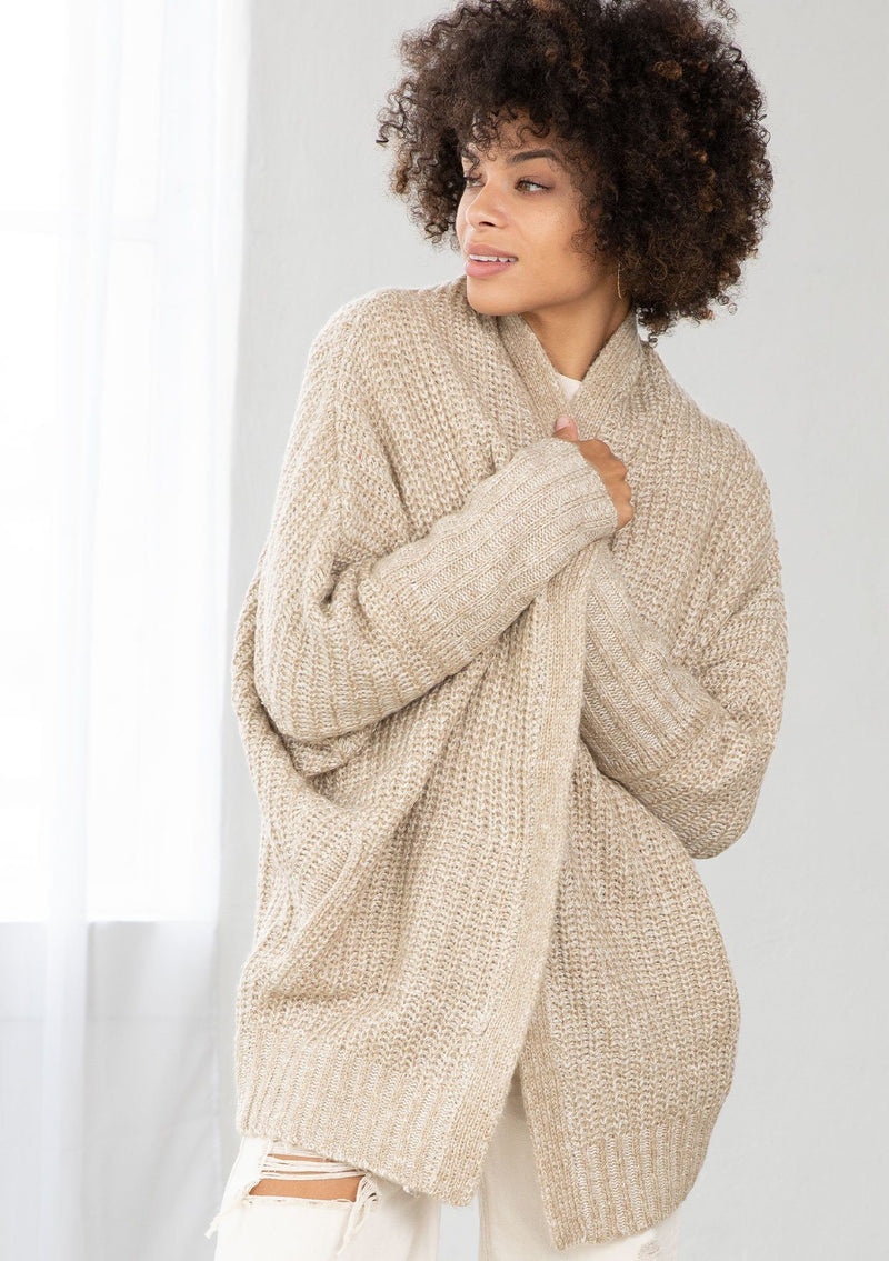 [Color: Oatmeal] An open knit marled cardigan. Featuring a flattering cocoon fit, a relaxed shawl collar, and essential side pockets.
