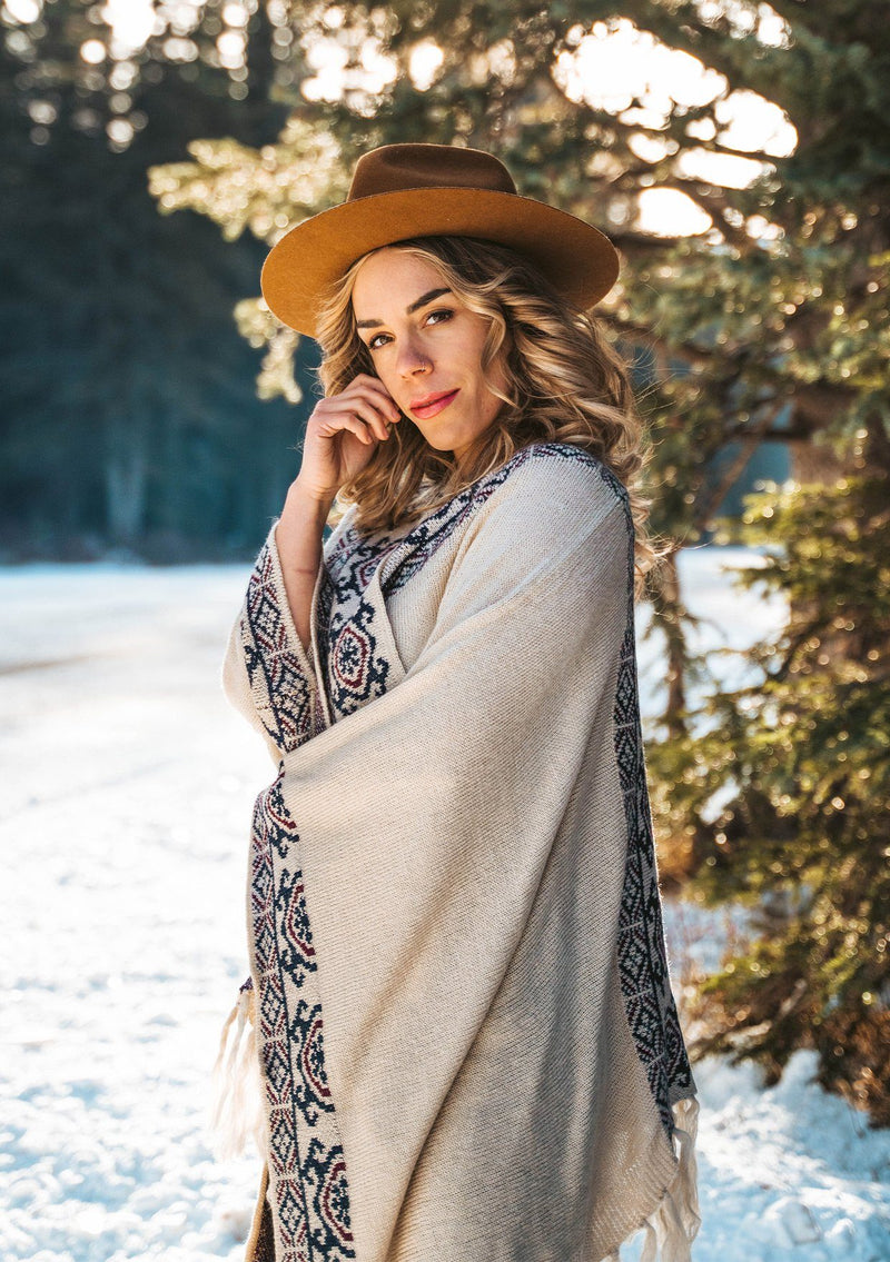 [Color: Natural/Midnight] The ultimate bohemian poncho sweater, in an eye catching Southwestern style pattern. Featuring a fringed handkerchief hemline, contrast ribbed details, and an easy open front. 