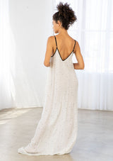 [Color: Black/Natural] A model wearing an off white maxi dress with black snail print design. Featuring a v neckline, adjustable spaghetti straps, and side pockets.