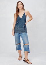 [Color: Dusty Navy] An image of a blonde model wearing a navy boho embroidered tank top with tassel ties. 
