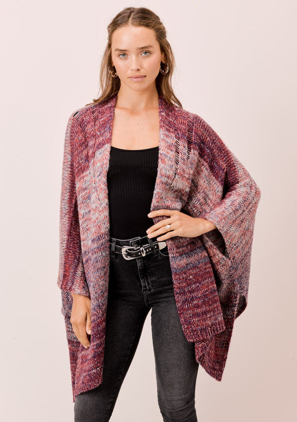 [Color: Cranberry Multi] A soft, oversize poncho cardigan in a space dye knit. Featuring an oversize, easy silhouette, an open front, and cool open knit details on the shoulder. A cozy bohemian style, paired here with jeans. 