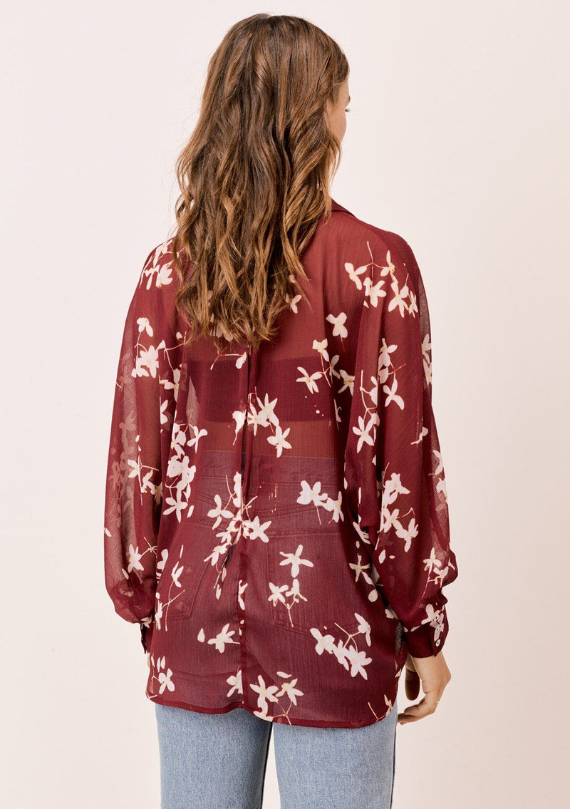 [Color: Brick/Rosewater] A versatile floral chiffon top, featuring long dolman sleeves and a billowy silhouette. Shown here with a camisole underneath.