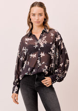 [Color: Midnight/Champagne] A versatile floral chiffon top, featuring long dolman sleeves and a billowy silhouette. Shown here with a camisole underneath.