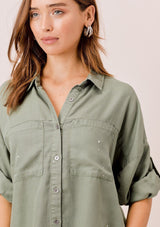 [Color: Olive] Lovestitch olive short sleeve, tencel, buttondown shirt with roll tab sleeves and paint splatter detail. 