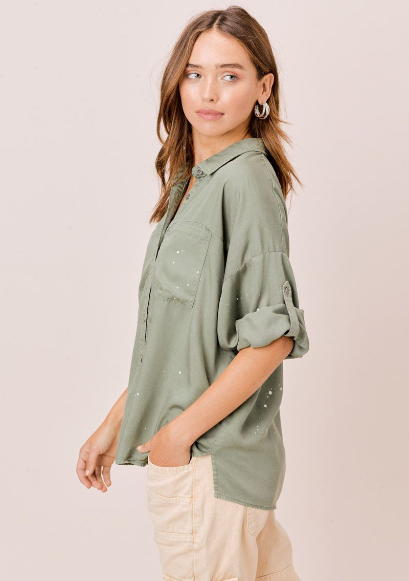 [Color: Olive] Lovestitch olive short sleeve, tencel, buttondown shirt with roll tab sleeves and paint splatter detail. 