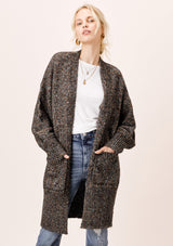 [Color: Black Multi] An oversize, relaxed fit cardigan in a beautiful multicolored knit. Featuring a subtle drop shoulder, long voluminous sleeves, and essential front pockets. 