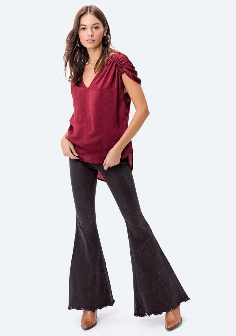 [Color: Red] A washed satin top, featuring a flattering gathered short sleeve detail, a plunging v neckline and gathered details along the back yoke. 