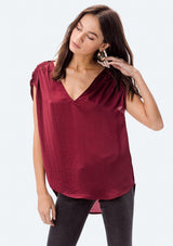 [Color: Red] A washed satin top, featuring a flattering gathered short sleeve detail, a plunging v neckline and gathered details along the back yoke. 