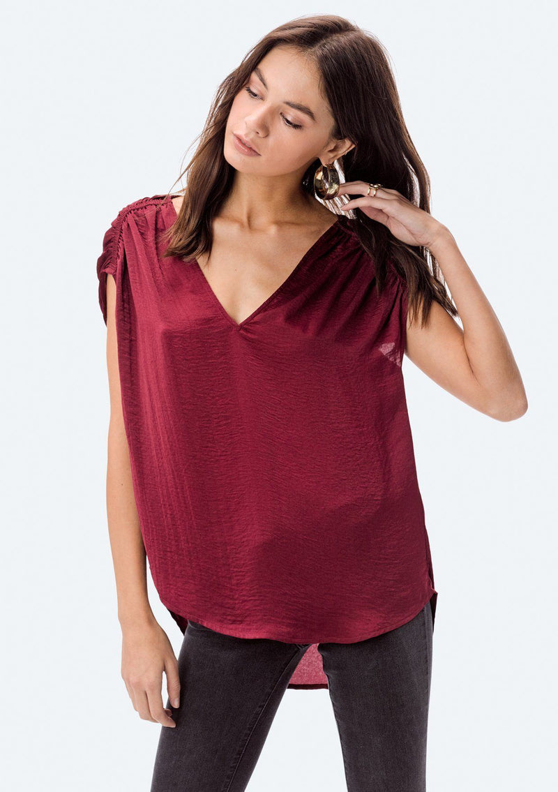 [Color: Red] A washed satin top, featuring a flattering gathered short sleeve detail, a plunging v neckline and gathered details along the back yoke. 