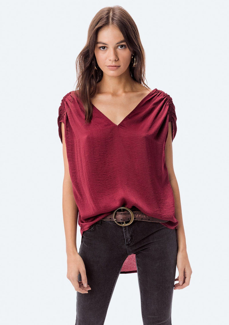 [Color: Red] A washed satin top, featuring a flattering gathered short sleeve detail, a plunging v neckline and gathered details along the back yoke. 