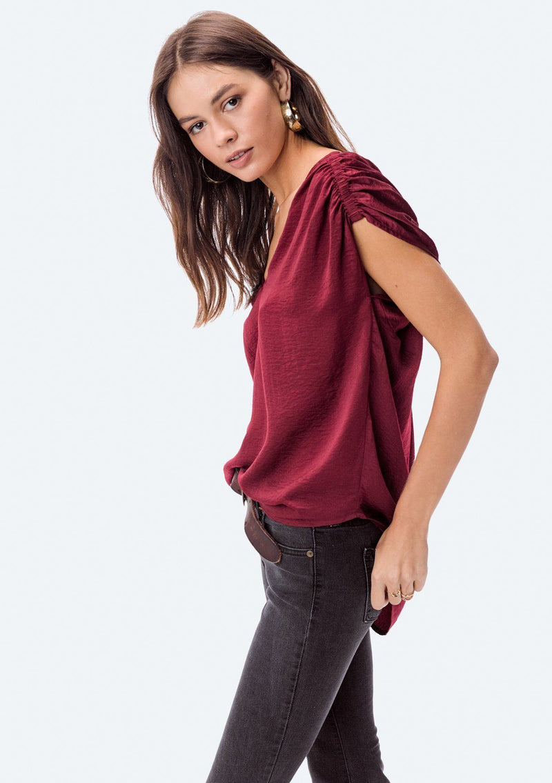 [Color: Red] A washed satin top, featuring a flattering gathered short sleeve detail, a plunging v neckline and gathered details along the back yoke. 