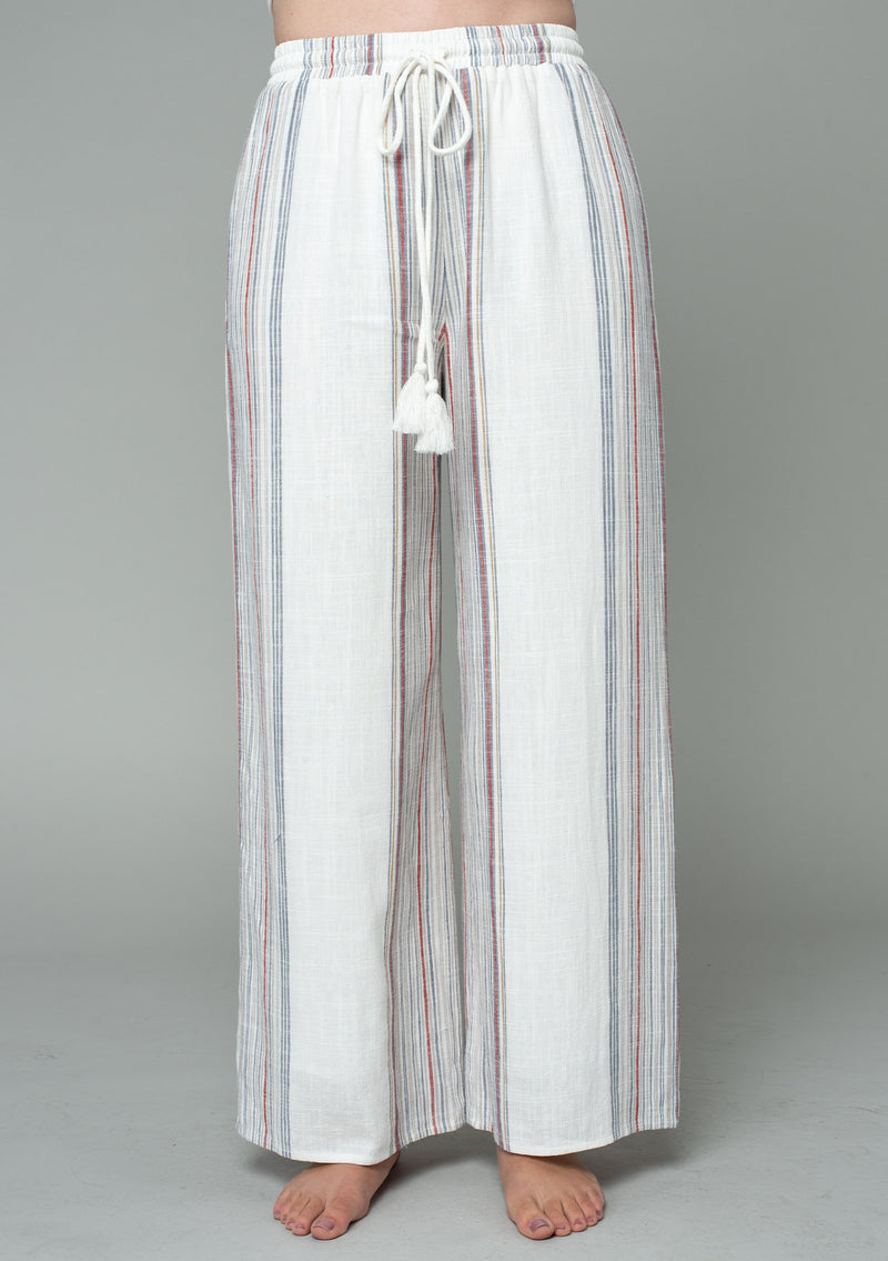 [Color: Ivory/Red] A half body front facing image of a model wearing an off white and red striped wide leg drawstring pant.