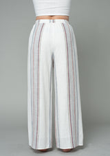 [Color: Ivory/Red] A half body back facing image of a model wearing an off white and red striped wide leg drawstring pant.