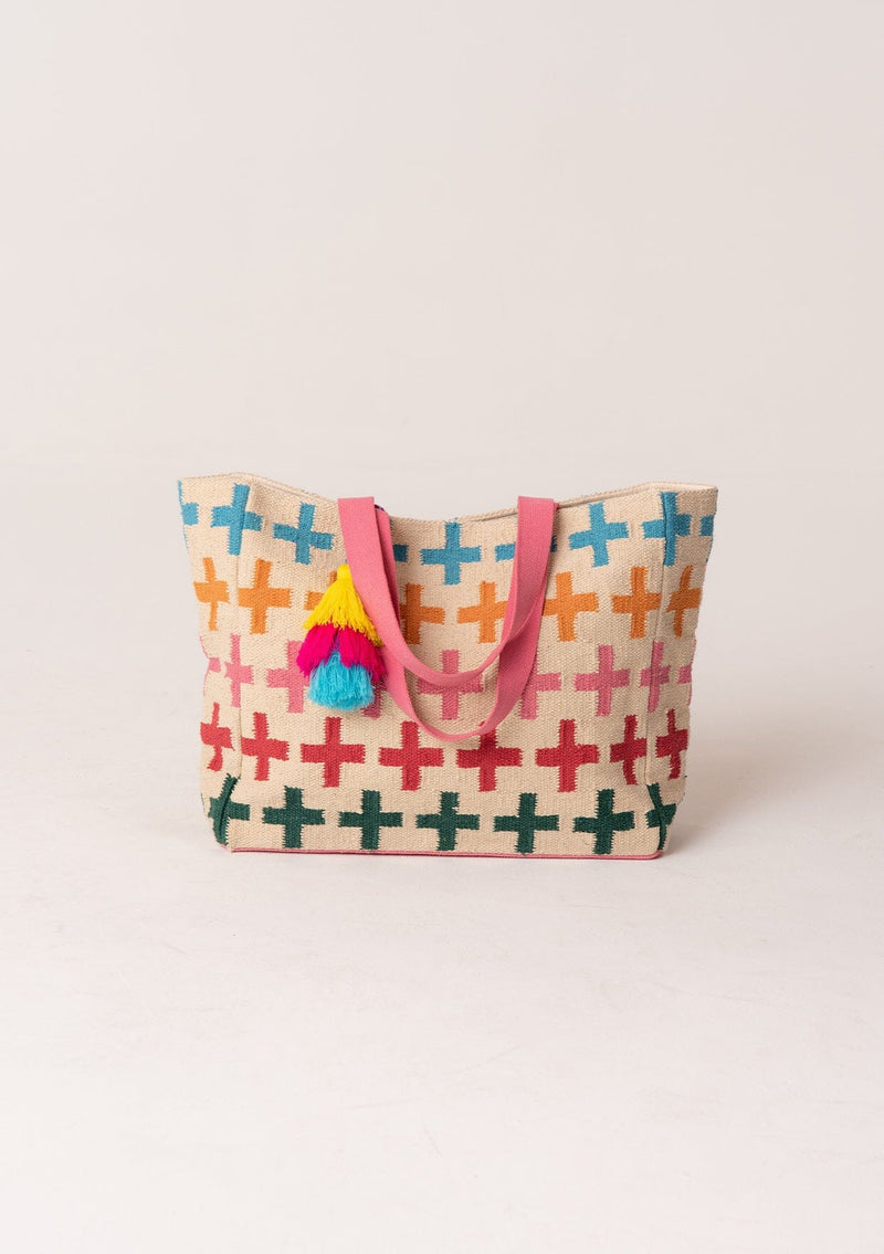[Color: Natural/Pink] A bohemian extra large tote bag with multi color cross design throughout. With two pink straps, an extra large tassel accent, and a magnetic closure. 