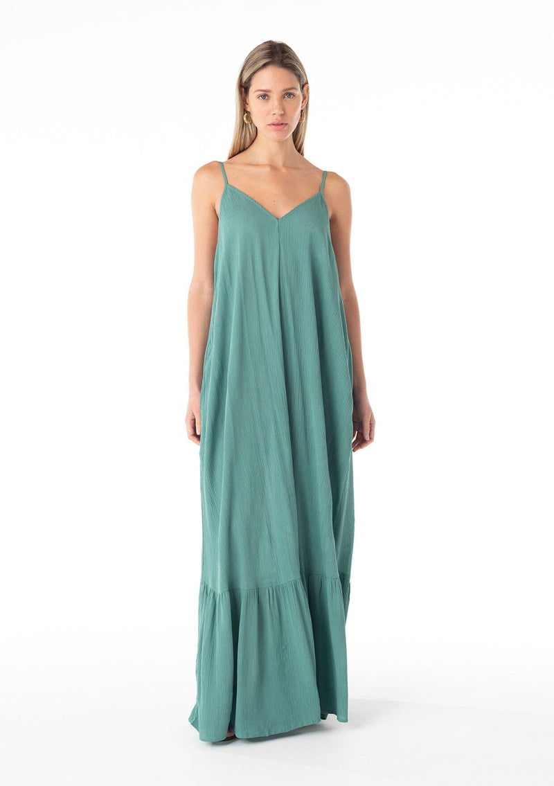 [Color: Seaglass Green] A front facing image of a blonde model wearing a simple flowy sleeveless maxi tank dress in a teal crinkle rayon. With a v neckline in front and back, adjustable spaghetti straps, and a tiered skirt. 