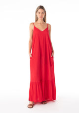[Color: Tomato] A front facing image of a blonde model wearing a simple flowy sleeveless maxi tank dress in a bright red crinkle rayon. With a v neckline in front and back, adjustable spaghetti straps, and a tiered skirt. 