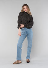 [Color: Black Multi] A full body front facing image of a blonde model wearing a chunky multi color knit sweater with a mock neckline and long voluminous sleeves. 