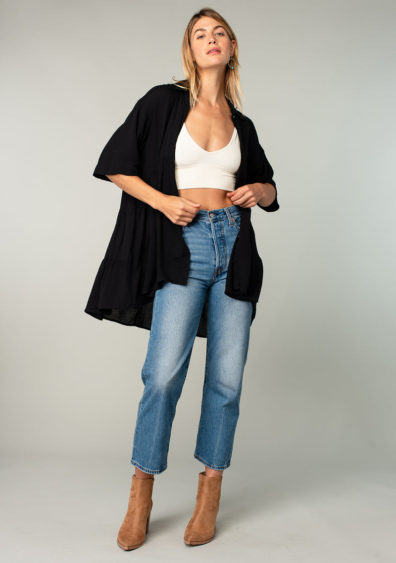[Color: Black] A model wearing a flowy black oversized collared tunic top.