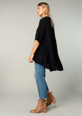[Color: Black] A model wearing a flowy black oversized collared tunic top.