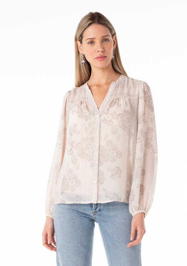 [Color: Natural/Taupe] A front facing image of a blonde model wearing a sheer chiffon bohemian spring blouse in a natural and taupe mixed floral print. With a button front, a v neckline, long sleeves, and a relaxed fit. 