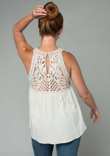 [Color: Vanilla Bean] A model wearing a cream colored crochet yoke tank top with a racerback and a flowy fit.