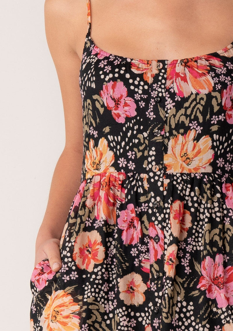 [Color: Black/Fuchsia] A close up front facing image of a blonde model wearing a pretty spring maxi dress in a black and pink floral print. With spaghetti straps, a scooped neckline, a flowy tiered skirt, a button front, and a half smocked elastic bodice at the back. 